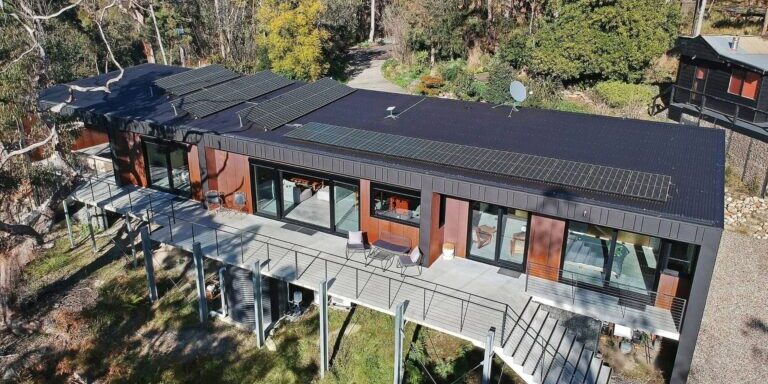 Aerial view of a Blue Eco Homes build with a metal roof, solar panels and raised deck on a bushland site in the Blue Mountains, NSW